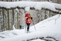 Women ski touring, late Winter - early Spring, in the Carpathian mountains, Romania. Girls with skis, backpacks, and poles. Royalty Free Stock Photo