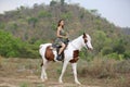 Women on skirt dress Riding Horses On field landscape Against forest.