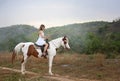 Women on skirt dress Riding Horses On field landscape Against forest. Royalty Free Stock Photo