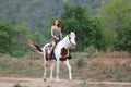 Women on skirt dress Riding Horses On field landscape Against forest.