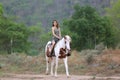 Women on skirt dress Riding Horses On field landscape Against forest.