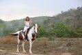 Women on skirt dress Riding Horses On field landscape Against forest.