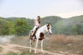 Women on skirt dress Riding Horses On field landscape Against forest.