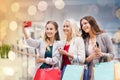 Women with smartphones shopping and taking selfie