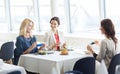 Women with smartphones taking picture of food