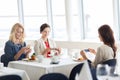 Women with smartphones taking picture of food