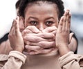 Women are societies most vulnerable. a young woman being silenced during a protest. Royalty Free Stock Photo