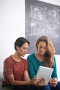 Women, sofa and tablet in office with discussion for feedback, creative startup or project research. Employees