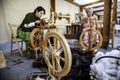 Women spinning thread with a wooden spinning wheel Royalty Free Stock Photo