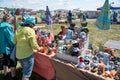 Women stand near the counter with crocheted toys at the Karatag festival of music and crafts. Royalty Free Stock Photo