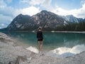 Women standing against amazing view of Braies Lake Lago with mountains reflected in lake water Dolomites Alps, Italy