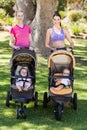 Women standing with the baby stroller Royalty Free Stock Photo