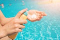 Women standing on the beach and using suncream. close up of women hands receiving sunblock cream lotio Royalty Free Stock Photo