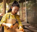 Women standing builder wearing checked shirt worker of construction site hammering nail in the wooden Royalty Free Stock Photo