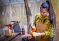 Women standing builder wearing checked shirt worker of construction site hammering nail in the wooden Royalty Free Stock Photo