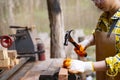 Women standing builder wearing checked shirt worker of construction site hammering nail in the wooden Royalty Free Stock Photo