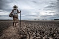 Women standing on dry soil and fishing gear, global warming and water crisis Royalty Free Stock Photo