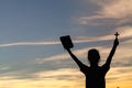 Women standing holding holy bible for worshipping God at sunset background, Pray to the god, christian silhouette concept