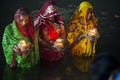 Women standing in river water at chhat puja