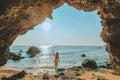 Women standing on a rock at the cave entrance Look at the sea and beautiful views. at sunset romantic atmosphere at Kho Larn ,