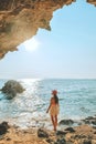 Women standing on a rock at the cave entrance Look at the sea and beautiful views. at sunset romantic atmosphere at Kho Larn ,