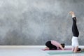 Women standing in salamba sirsasana exercise and balasana Royalty Free Stock Photo