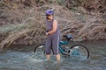 Women in stream with bike