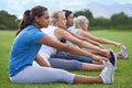 Women, stretching legs and exercise in park, sports field and nature with fitness team for health and wellness. Athlete Royalty Free Stock Photo