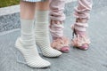Women with striped and pale pink high heel shoes before Emporio Armani fashion show, Milan Fashion Week