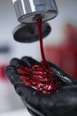 women stylist in gloves preparing red cream for creativ dying hairin, a mask for treatment procedure in beauty salon.