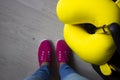 Women with suitcase and yellow pillow preparing for journey