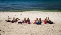 4 Women sunbathing at the beach Royalty Free Stock Photo