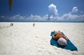 Women is sunburning on the sandy beach Royalty Free Stock Photo