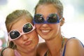 Women, sunglasses and silly portrait at festival in nature, excited and reunion for bonding together. Friends, funny