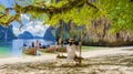 women on a swing at the Tropical lagoon of Koh Loa Lading Krabi Thailand part of Koh Hong Islands