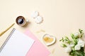 Women table top view, cute feminine stuff on beige background. Home office desk, beauty blogger desktop, girls diary, coffee cup,