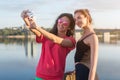 Women taking picture of herself, selfie at beach Lifestyle sunny image best friend girls happy vacations.