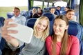 Women taking selfie by smartphone in travel bus Royalty Free Stock Photo