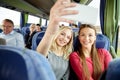 Women taking selfie by smartphone in travel bus Royalty Free Stock Photo