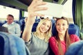 Women taking selfie by smartphone in travel bus Royalty Free Stock Photo