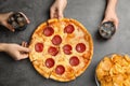 Women taking tasty pepperoni pizza at table, top view Royalty Free Stock Photo