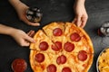 Women taking tasty pepperoni pizza at table, top view Royalty Free Stock Photo