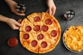 Women taking tasty pepperoni pizza at table, top view Royalty Free Stock Photo