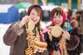 Women tasting pancake during Shrovetide