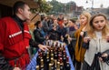 Women tasting wine with bartender in national georgian costume at festival