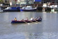 Women team practicing rowing at The dock in Harbourside area of Bristol city