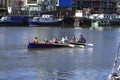 Women team practicing rowing at The dock in Harbourside area of Bristol city