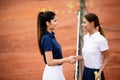 Women tennis player handshaking after playing a tennis match. Fairplay, sport concept. Royalty Free Stock Photo