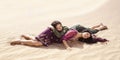 Women thirsty laying in a desert. Lost in desert durind sandshtorm Royalty Free Stock Photo