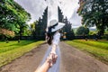 Women tourists holding man`s hand and leading him to Big Gate in Bali, Indonesia.